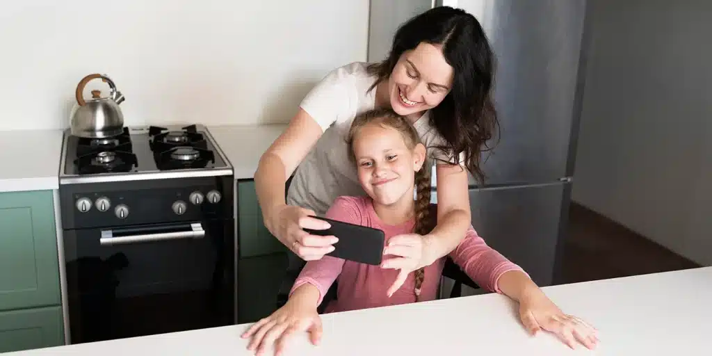 a woman and a girl taking a selfie