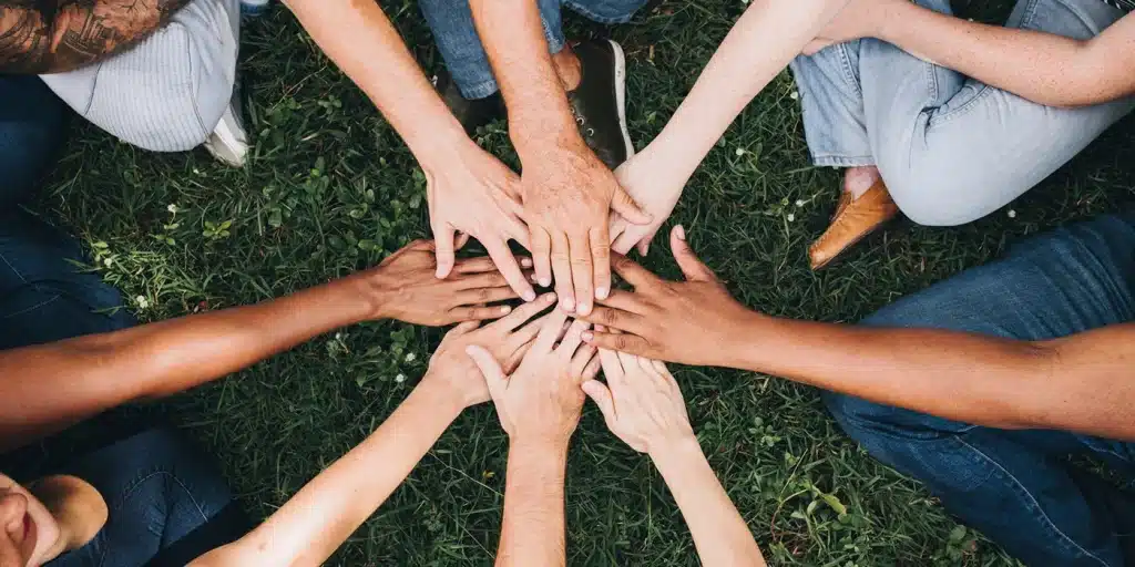 a group of people putting their hands together