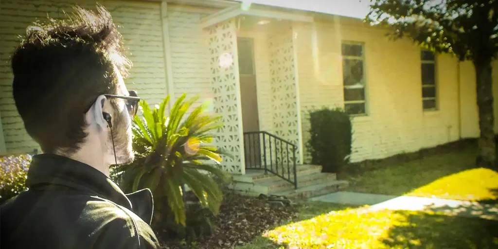 a man standing in front of a house