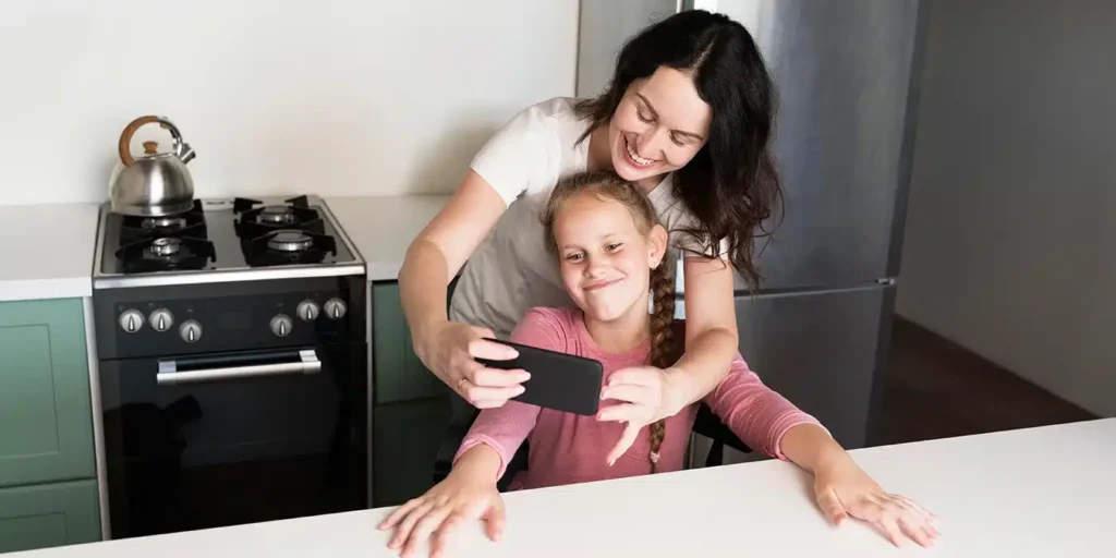 a woman and a girl taking a selfie