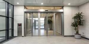 An automatic door closer with a sensor installed on a commercial glass door.