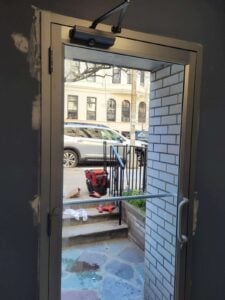 a door with a glass door and a railing