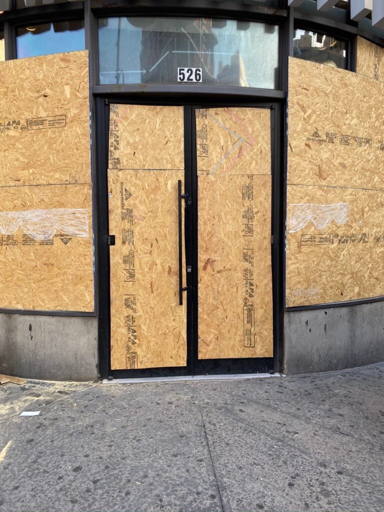 Locked commercial storefront at 526 with secured double doors - 24/7 business lockout service by Golden Key Locksmith NYC