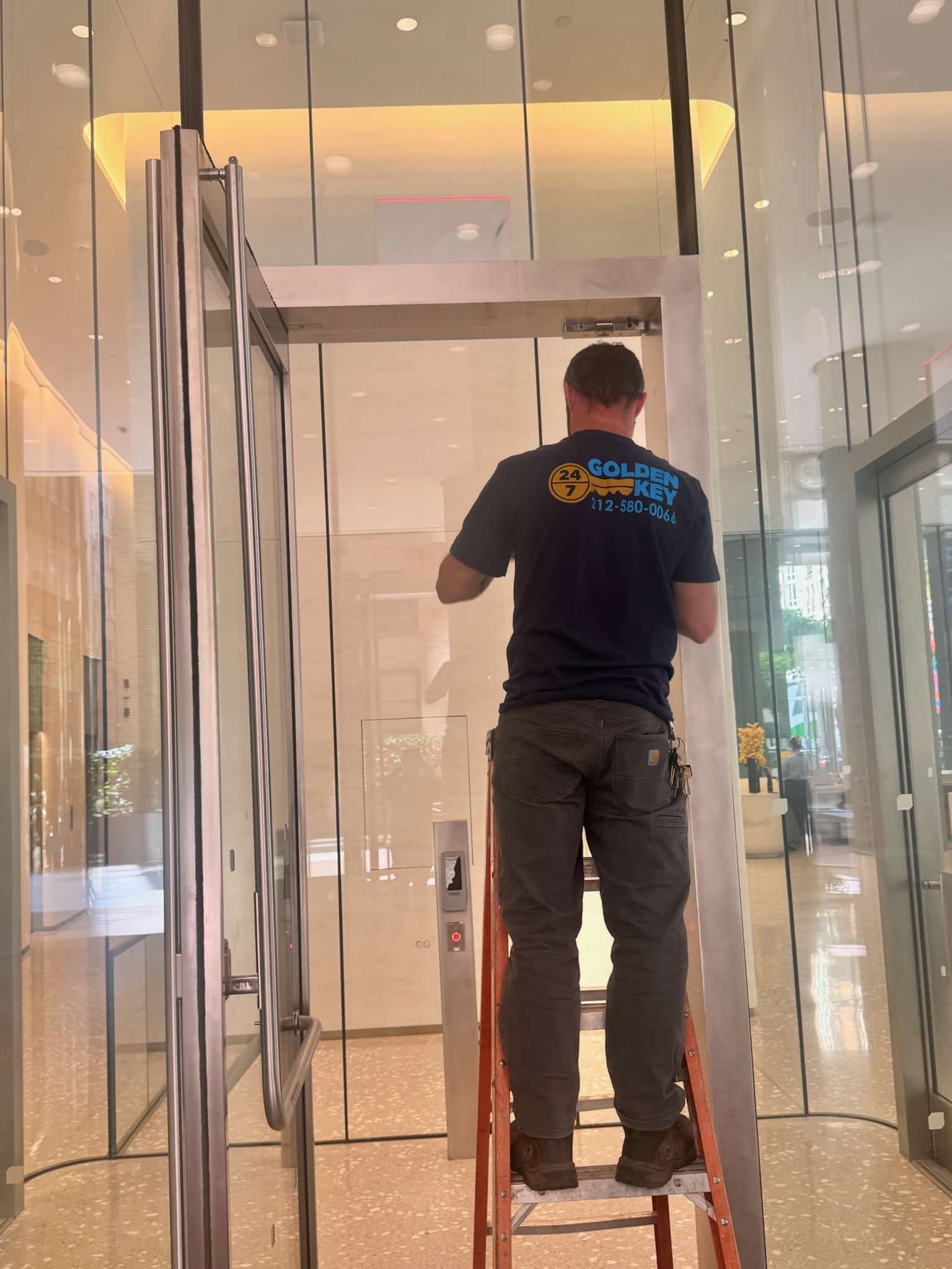 a man standing on a ladder in a building