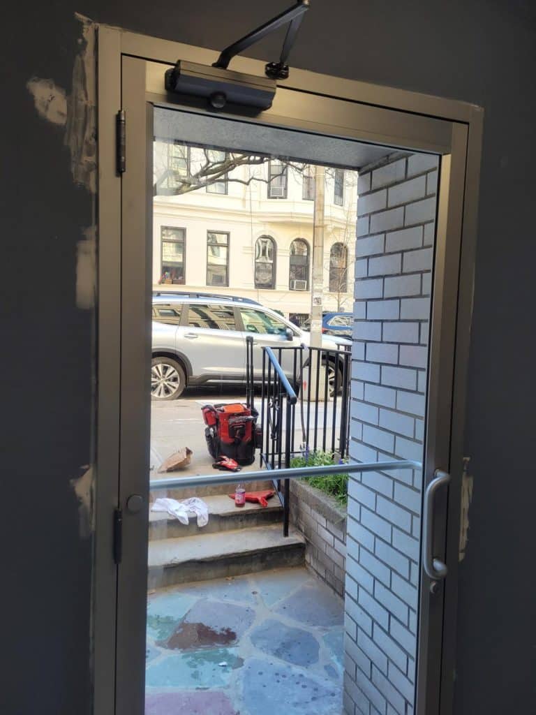 a door with a glass door and a railing
