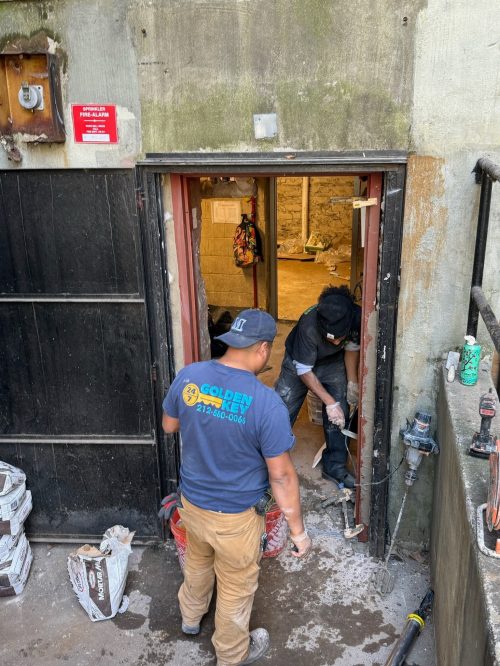 Golden Key Locksmith NYC emergency crew performing urgent door repair at a NYC building