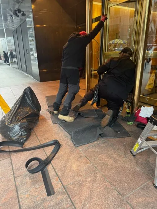Golden Key Locksmith NYC Brooklyn team repairing commercial revolving door - professional door service