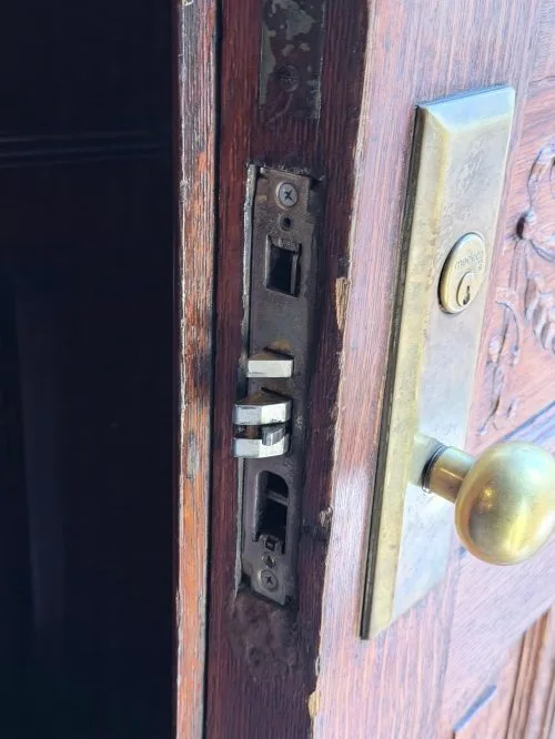 Medeco mortise lock mechanism being repaired on a vintage wooden door by Golden Key Locksmith NYC