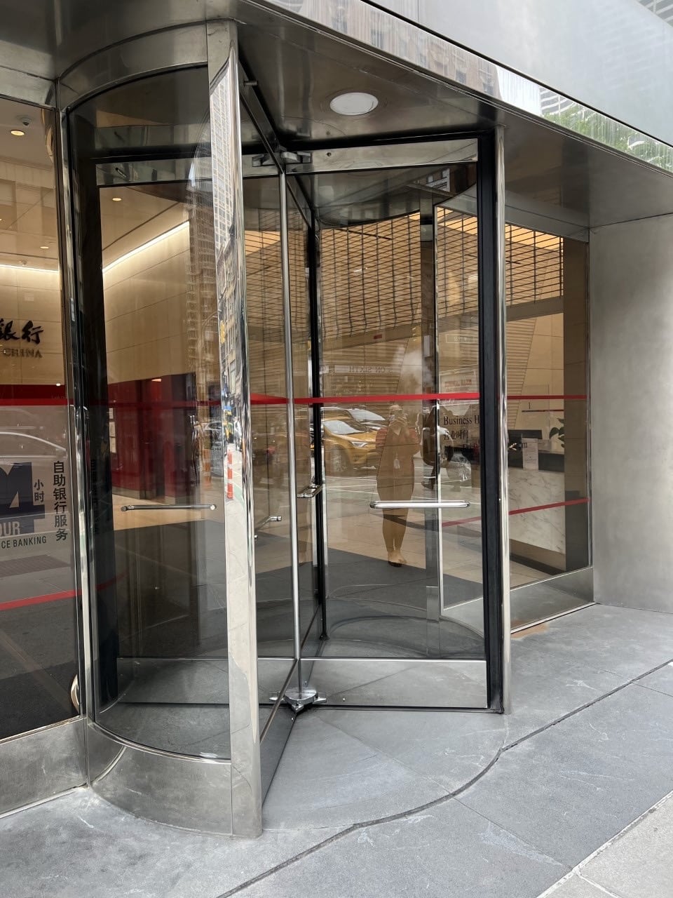 Automatic revolving door at a commercial bank entrance in Manhattan
