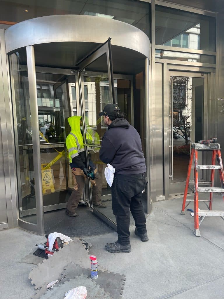 Licensed and insured Golden Key Locksmith NYC locksmith securing a building entrance near a brownstone entrance in Lincoln Square, Manhattan NYC